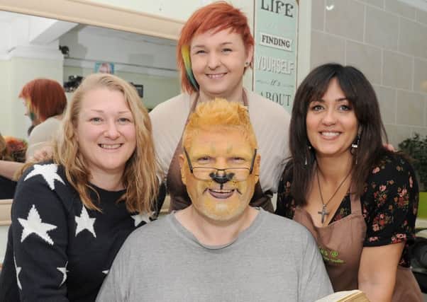 The Rev Sean Blackman at the start of his challenge on November 1, when he was transformed into the charachter of Aslan from The Lion, Witch and the Wardrobe. He's pictured with, from left, face paint artist Rebecca Baird, owner of Diva Hair Studio Amber Roper and hairdresser Kes Suffield 

Picture: Sarah Standing (161484-9473)