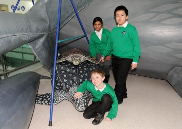 Anika Rahman and Tawhid Ahmen with, front, Alfie Sheperd  at Portsmouth International Portwith some of the life-sized inflatable sea creatures on displayPicture: Sarah Standing (170180-6335)