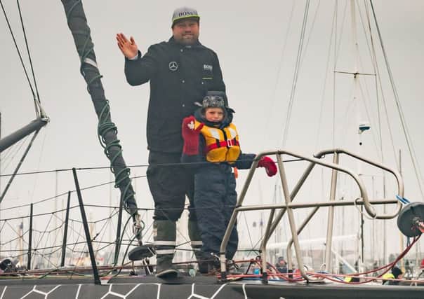 Alex Thomson coming back into Gosport with his son Oscar Picture: Keith Woodland (170197-007)