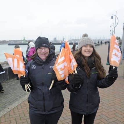 Hugo Boss team members Maddie Gunney and Stephanie Harding handing out flags 
Picture: Ian Hargreaves (170211-02)