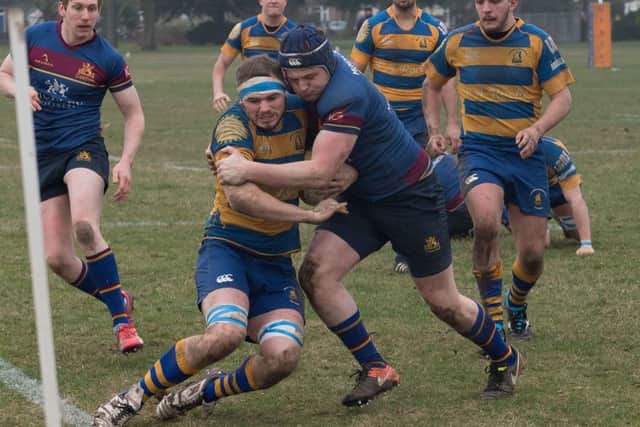 Gosport & Fareham's Rhys Bingham is dragged into touch. Picture: Keith Woodland (170198-187)