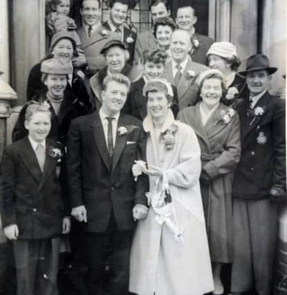Alan and Shirley Wareham, front, with family and friends on their wedding day in 1957. PPP-170802-162350001