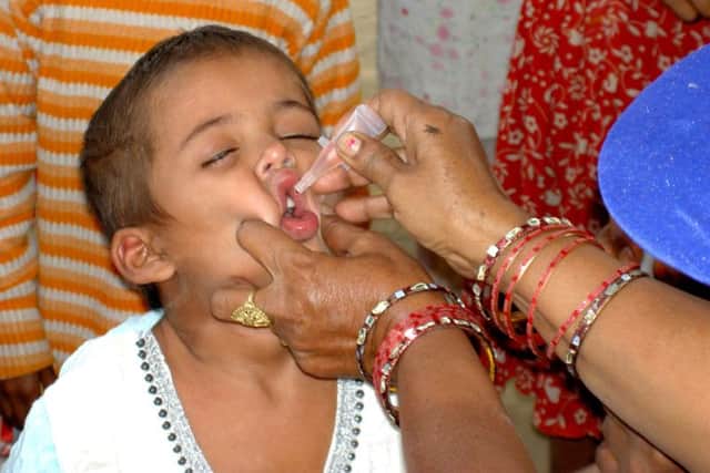 A child in Delhi is issued with a potentially life-saving Polio vaccination