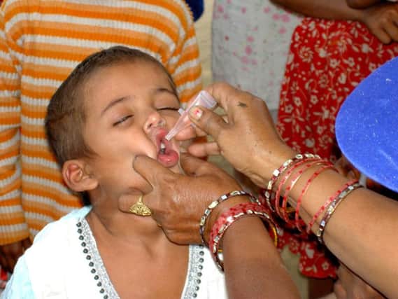 A child in Delhi is issued with a potentially life-saving Polio vaccination