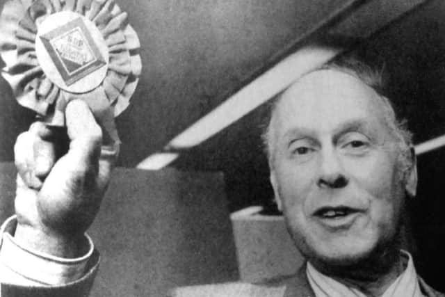 Jubilant Jim Murray holds his Alliance rosette high after winning the by-election (6740-1)