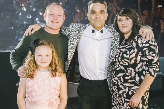 Robbie Williams with Danielle Howting, her partner Mike Bingham and their daughter Grace Picture: Andrew Whitton