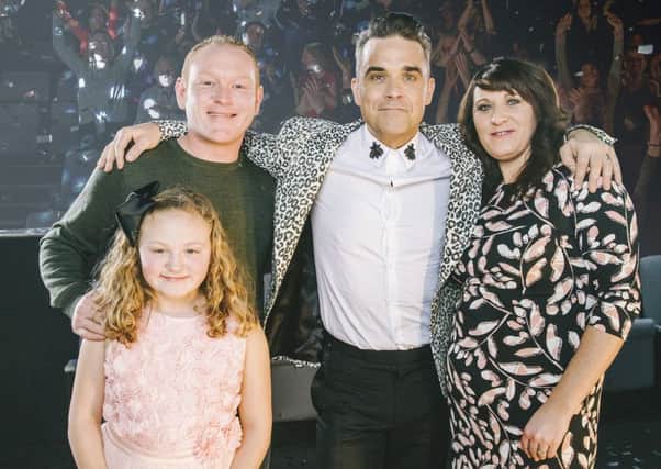 Robbie Williams with Danielle Howting, her partner Mike Bingham and their daughter Grace Picture: Andrew Whitton