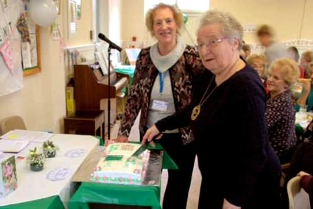 Maurenn Levenson, Hampshire WI chairman, cuts the cake