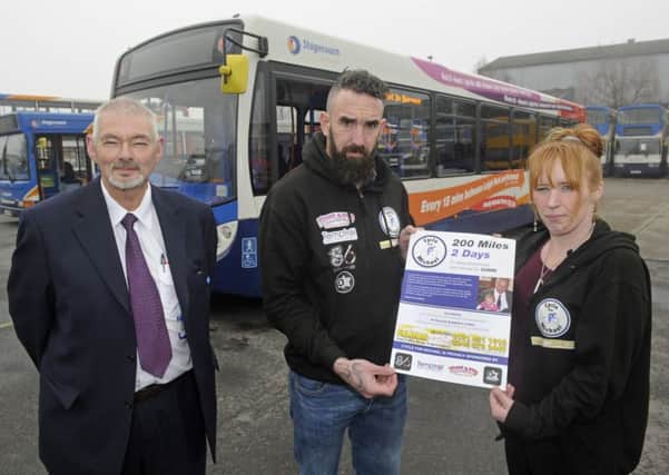 George Gibson, left, from Stagecoach with Eugene Scardifield and his sister Becky Roe-Stacey who have been allowed to place fundraising posters in buses in memory of their brother Michael Scardifield who was murdered.  Picture Ian Hargreaves (170214-1)