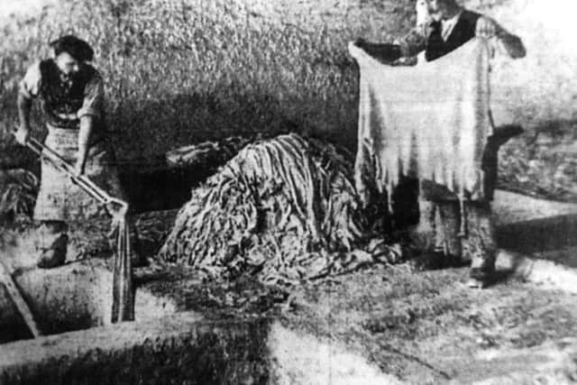 Skins being soaked in a lime pit ready for glove-making