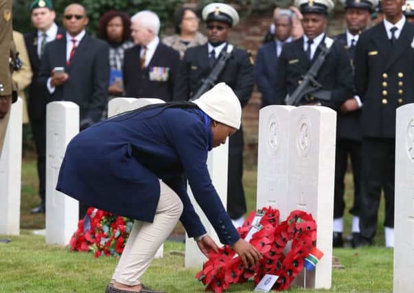 Family members laying wreath near the graves