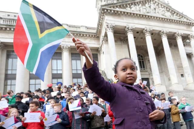 Karabo Tigedi, four, holding the South Africa flag outside Portsmouth Guidhall
