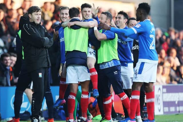 New Barnet boss Kevin Nugent, left, cuts a frustrated figure as Conor Chaplin celebrates his late Pompey leveller   Picture: Joe Pepler