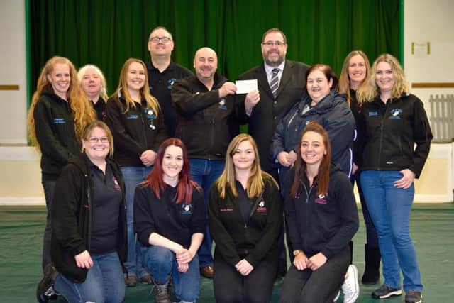 The Academy of Modern Canine Behaviour & Training present the cheque to Portsmouth Stray Dog Kennels