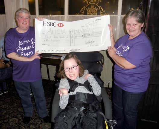 Les Heyhoe BCAv, left, presents Alicia Pannell with a cheque for Â£10,006.05, which will be used to fund a specially designed wheelchair and hoists around the house.

CAPTION: Alicia Pannell, centre, is presented with a cheque for Â£10,006.05.