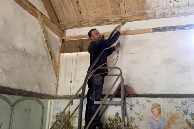 John Grant from Airstrip sandblasting Butser Ancient Farm's Roman villa. The villa is in desperate need of renovation, and work to improve facilities have already begun.
CAPTION: John Grant from Airstrip working on the Roman villa.