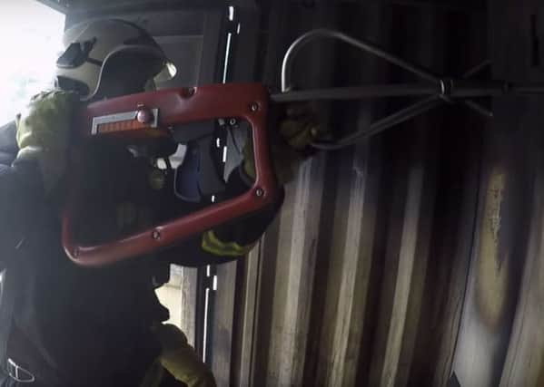 A firefighter using a high pressure lance. Credit: Chief Fire Officers Association/YouTube