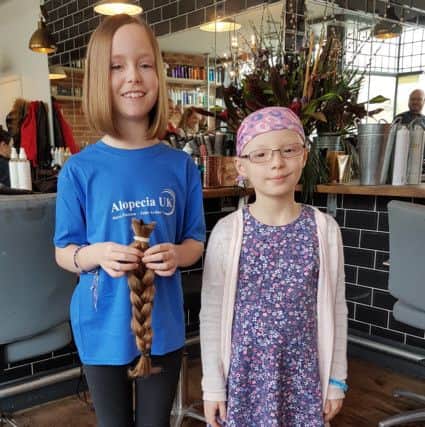 Cheryl Gibbs' niece Hollie, right, who has alopecia, and Amy Norton, 10, who cut her hair off for a wig-making charity