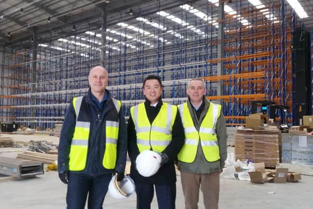 Alan Mak, centre, with chief executive Anthony Thompson and infrastructure director Simon Ratcliffe from FatFace at Dunsbury ParkCAPTION: Alan Mak, centre, at the Dunsbury Park development site.