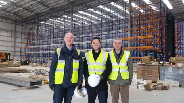 Alan Mak, centre, with chief executive Anthony Thompson and infrastructure director Simon Ratcliffe from FatFace at Dunsbury Park

CAPTION: Alan Mak, centre, at the Dunsbury Park development site.