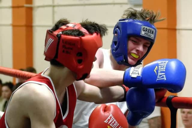 Leigh Parks Rhys McNamara, left, and Mason Barr, Copnor, exchange blows during last Saturdays England Boxing Junior Championships at Leigh Park ABC Picture: Neil Marshall