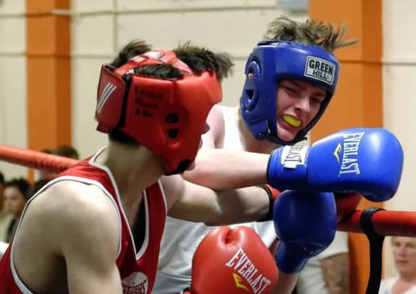 Leigh Parks Rhys McNamara, left, and Mason Barr, Copnor, exchange blows during last Saturdays England Boxing Junior Championships at Leigh Park ABC Picture: Neil Marshall