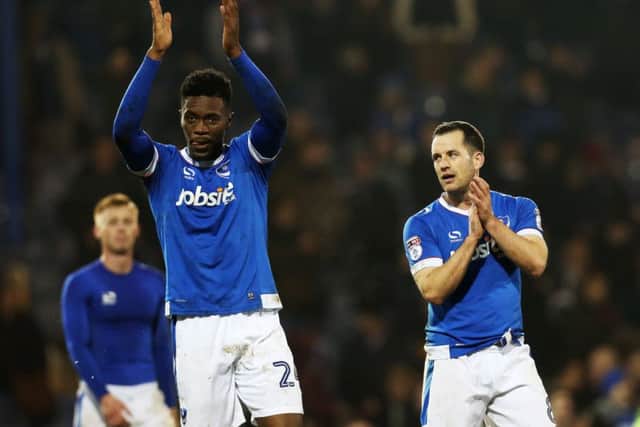 Amine Linganzi, left, has impressed Pompey skipper and defensive-midfield partner Michael Doyle, right, since returning to the Blues' starting XI Picture: Joe Pepler