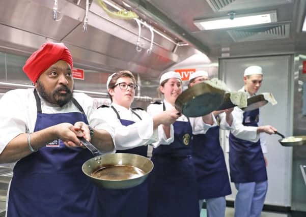 Celebrity Chef Tony Singh judging HMS Queen Elizabeth pancake competition.
 Six junior chefs created recipes and cooked them  in the galley