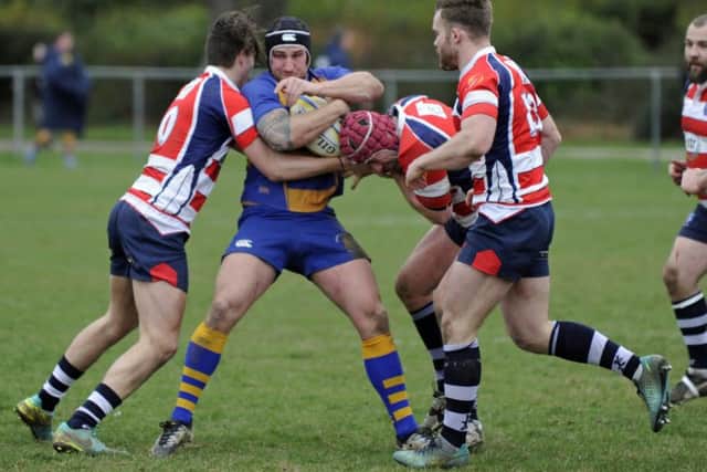 Havant players swarm around Gosport & Fareham's Wayne Dugan. Picture: Ian Hargreaves (170225-1)