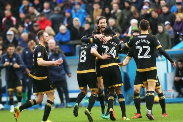 Amine Linganzi is congratulated by his Pompey team-mates after making it 2-0. Picture: Joe Pepler