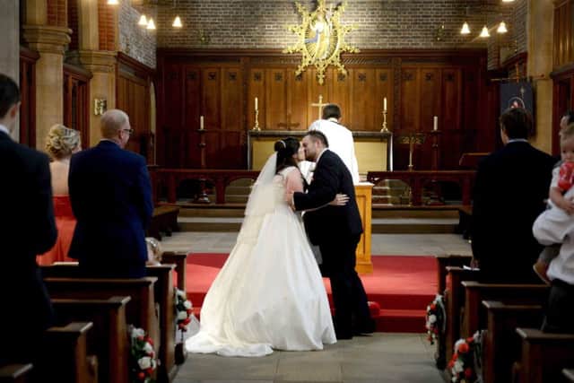 Katie and Ryan Earle seal the deal with a kiss at St James' Church, Milton. Picture: Mark Robbins Photography