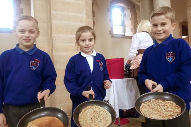 St Jude's Primary pupils Lucas Savage, Farrah Delaney-Melville, and Jasper DiMarco had pancakes at Portsmouth Anglican Cathedral