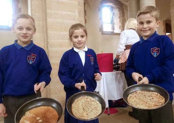 St Jude's Primary pupils Lucas Savage, Farrah Delaney-Melville, and Jasper DiMarco had pancakes at Portsmouth Anglican Cathedral