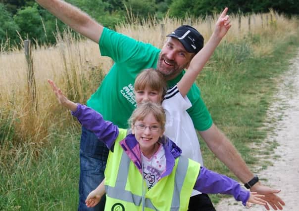 Kiernan Easton with his daughters at QE parkrun. Picture: Penny Johnstone