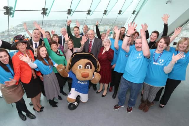Guests and volunteers celebrate the launch of this year's Moonlit Memories walk at the Spinnaker Tower