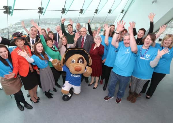 Guests and volunteers celebrate the launch of this year's Moonlit Memories walk at the Spinnaker Tower