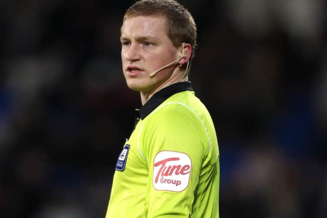 Referee John Busby