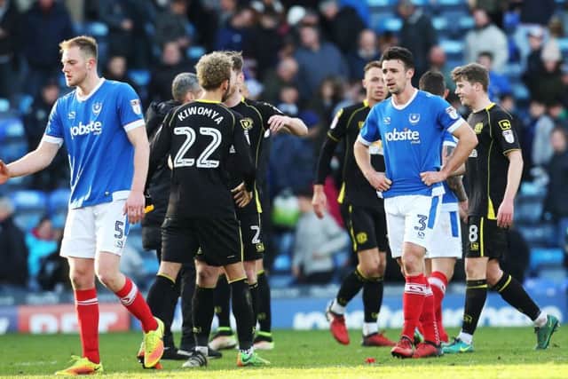 The Pompey players look distraught at the final whistle Picture: Joe Pepler