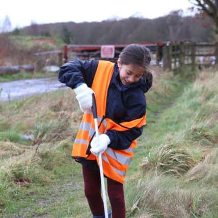 Halle Strange, 11, cleaning up in the rain at Knowle Village Hall, Fareham