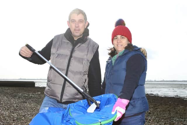 Andy and Maryam Sharp picking up litter on the beach