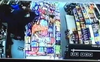 This CCTV shows a shop worker at AJ's Convenience Store struggling to stop a robber armed with a knife