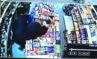 This CCTV shows a shop worker at AJ's Convenience Store struggling to stop a robber armed with a knife