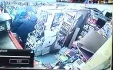 This CCTV shows a shop worker at AJ's Convenience Store struggling to stop a robber armed with a knife