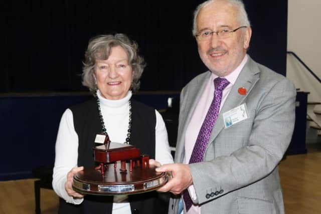 Marjorie Smale, left, receives her award from adjudicator Richard Deering