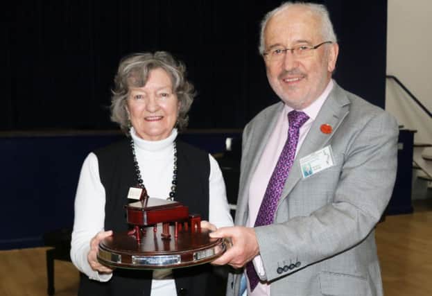 Marjorie Smale, left, receives her award from adjudicator Richard Deering