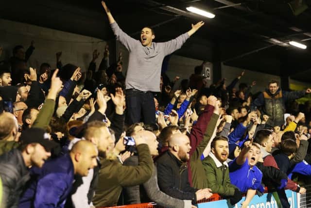 Pompey fans celebrate the victory at the Broadfield Stadium. Picture: Joe Pepler