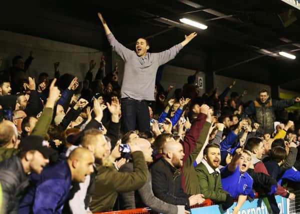 Pompey fans celebrate the victory at the Broadfield Stadium. Picture: Joe Pepler