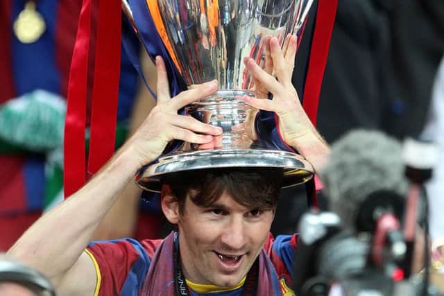 Lionel Messi lifts the UEFA Champions League trophy