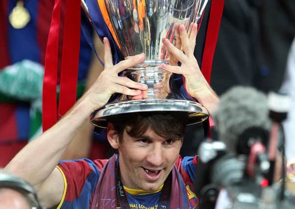 Lionel Messi lifts the UEFA Champions League trophy