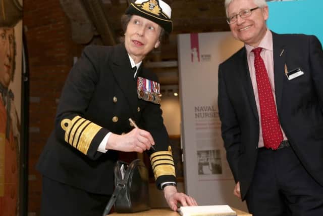 Princess Anne signs the guest book with Professor Dominic Tweddle Picture: Habibur Rahman (170350-77)